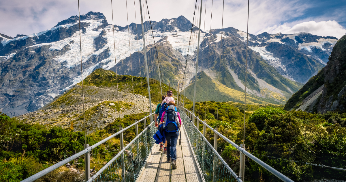 The Hooker Valley Track in Aoraki / Mount Cook National Park, with a view of snow-capped mountains and a glacial lake.