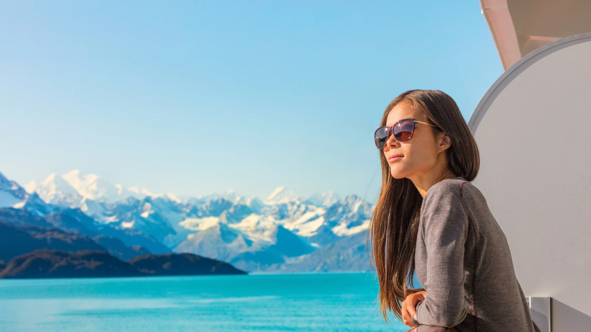 Blog_Beyond-the-Balcony-Unveiling-the-Best-Cruise-Cabins-for-Every-Traveler_woman-stood-on-cruise-ship-balcony