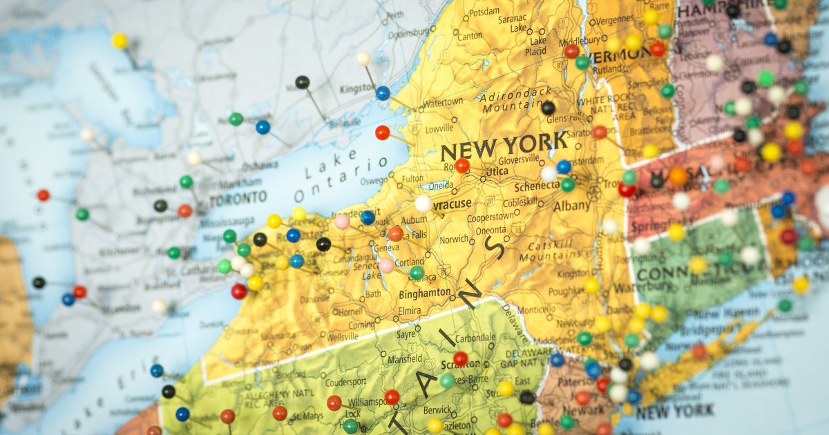 A map of the northeastern United States with colorful pins marking cities like New York, Boston, and Philadelphia.