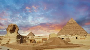 The Great Sphinx and the Pyramids of Giza at sunset.