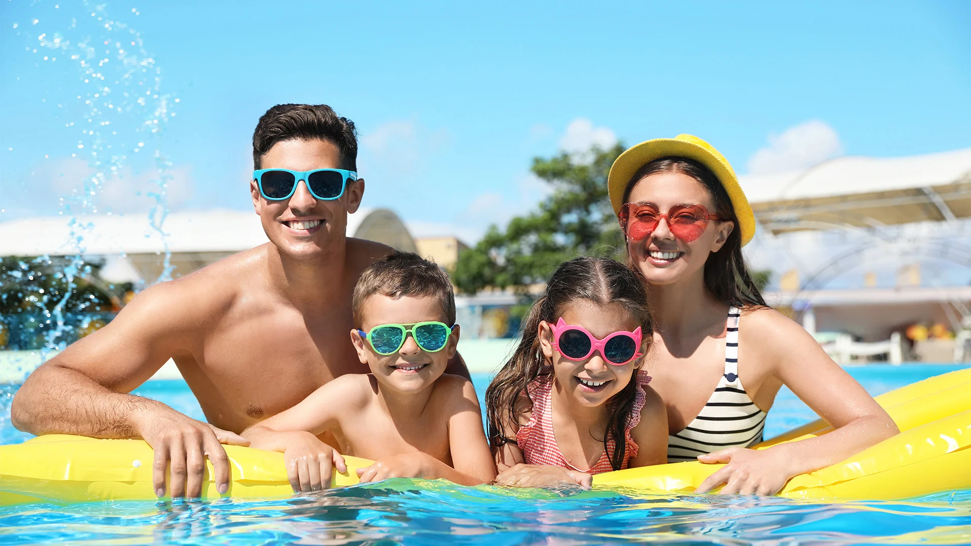 Family Holidays, Smiling Family with Inflatable in the Pool
