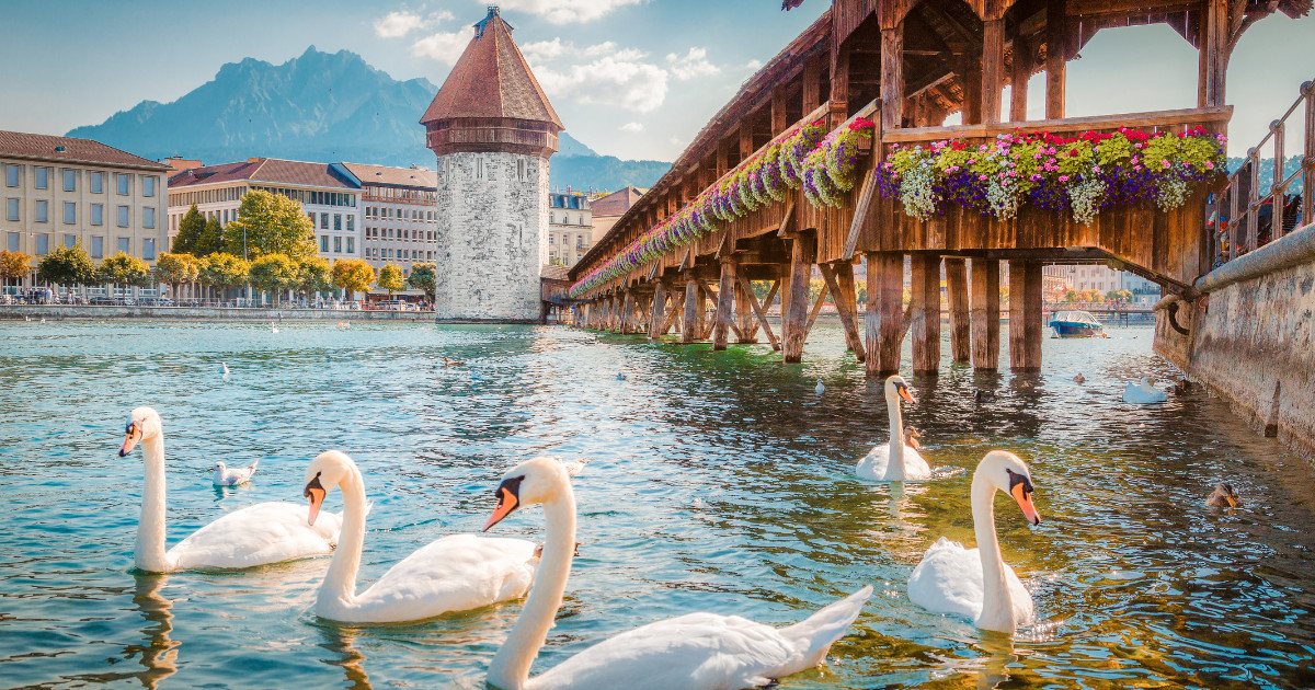 Historic city center of Lucerne with famous Chapel Bridge, the city's symbol and one of the Switzerland's main tourist attractions, and Mount Pilatus peak