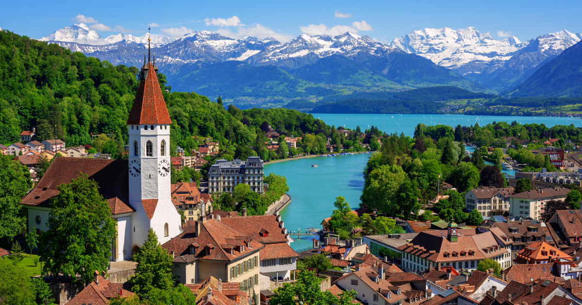 Historical Thun city and lake Thun with snow covered Bernese Highlands swiss Alps mountains in background, Canton Bern, Switzerland