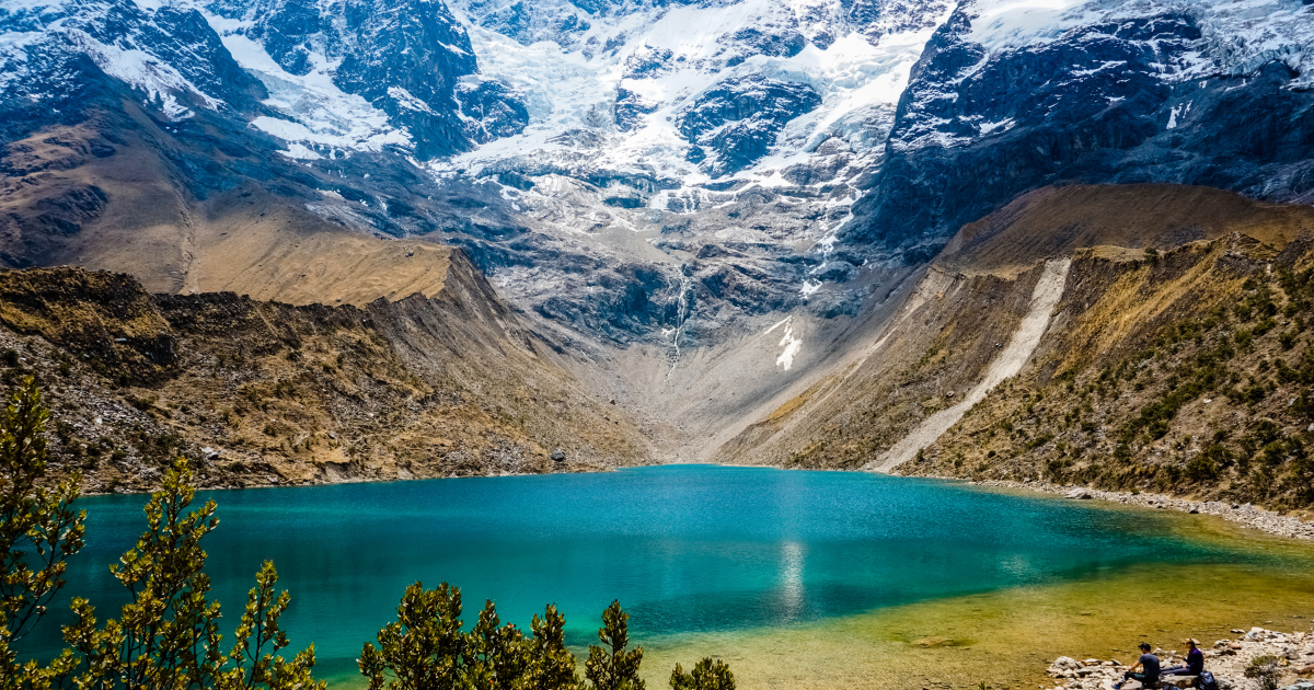 Laguna Humantay, a turquoise lake surrounded by snow-capped mountains in the Peruvian Andes.