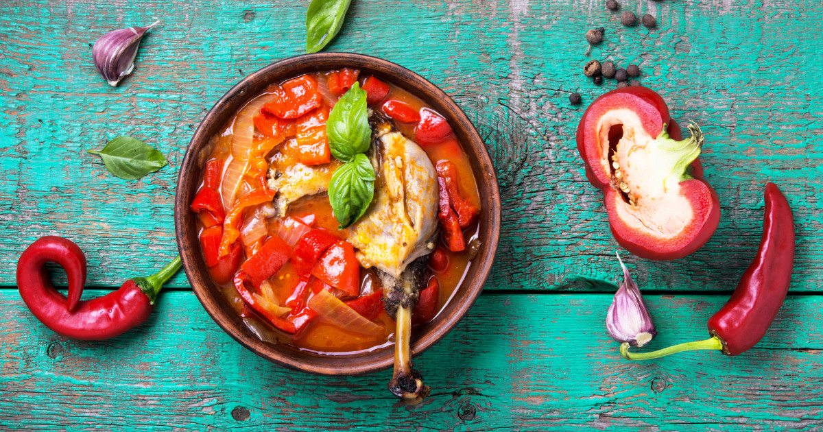 A dish of Paprikash, a Hungarian chicken stew with bell peppers, onions, and a creamy paprika sauce.