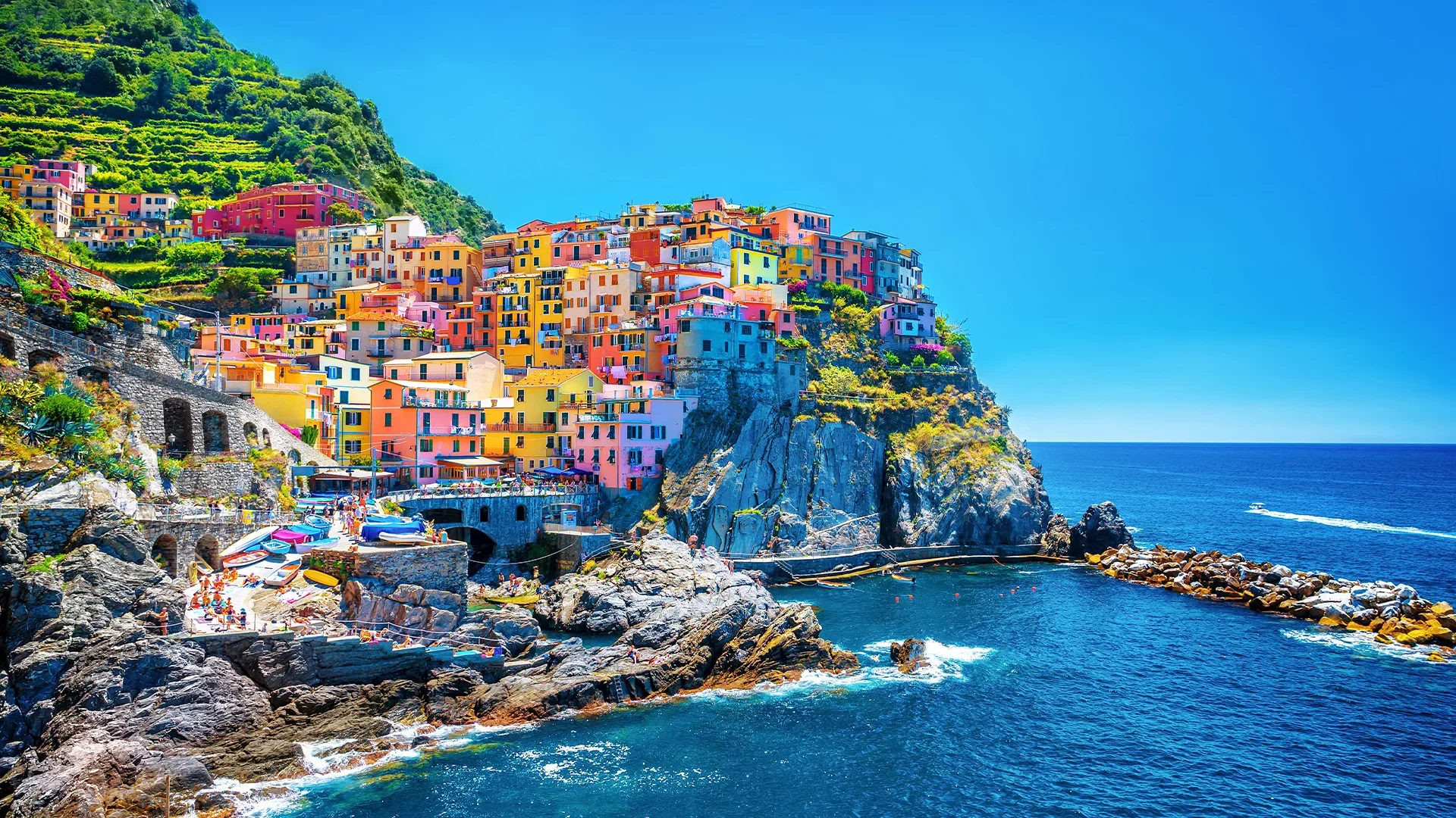 The colorful houses of Manarola, perched on a cliff overlooking the Mediterranean Sea.