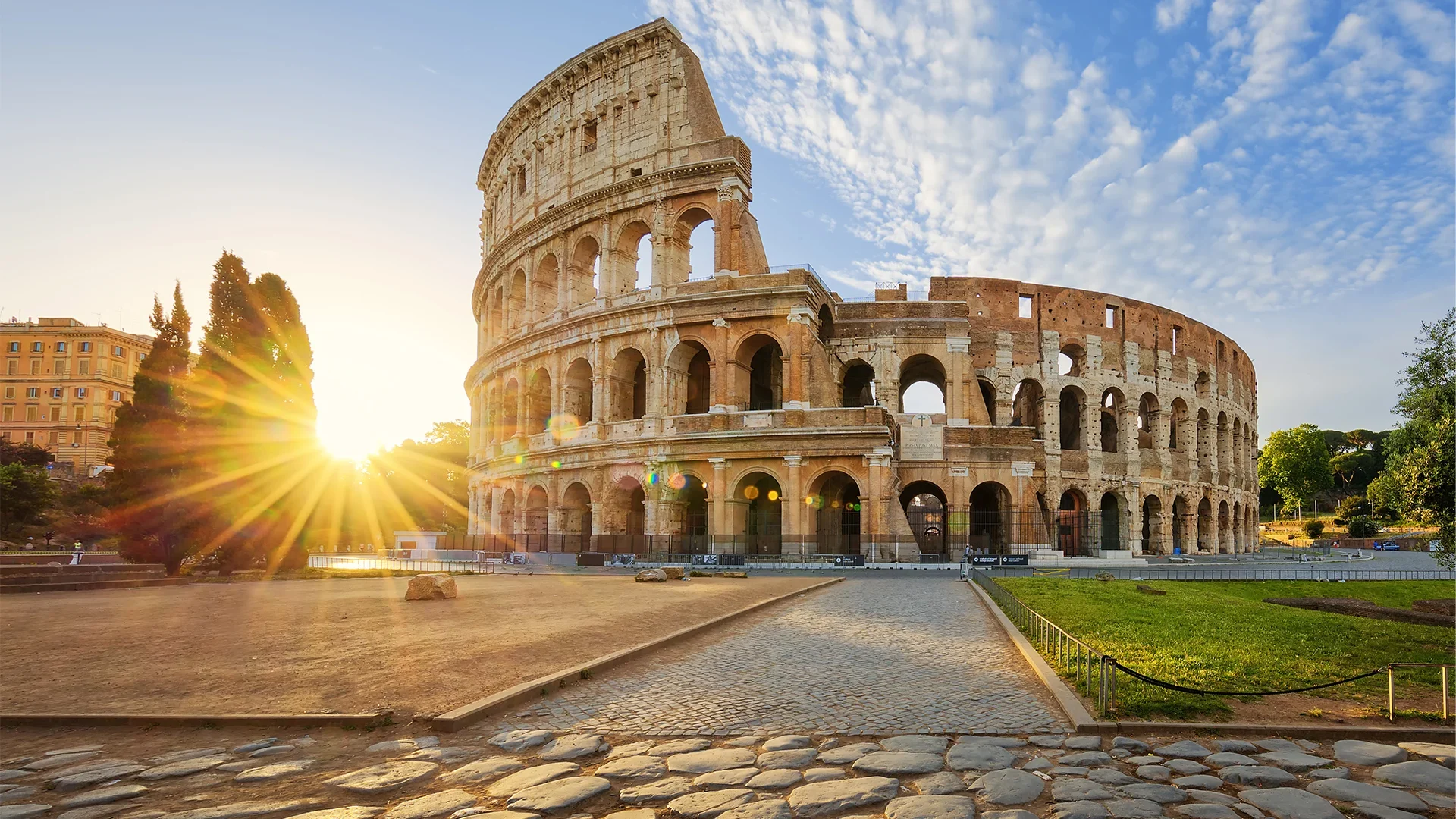 The iconic Colosseum in Rome, illuminated by the morning sun.
