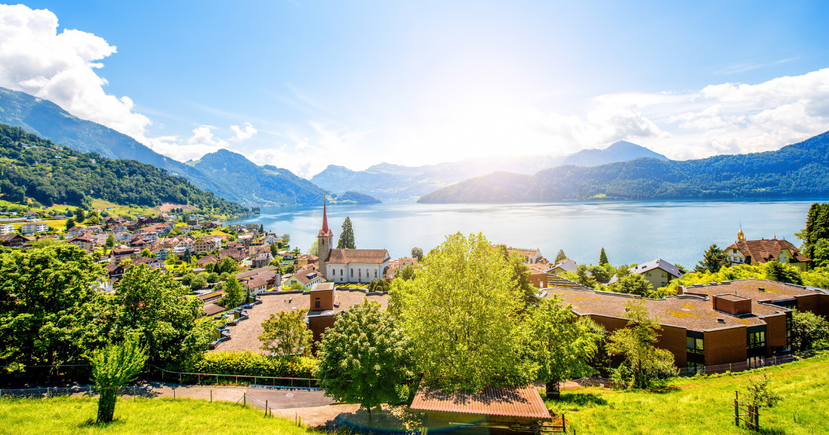 Landscape view on Weggis village on Lucerne lake with beautiful mountains on the background in Switzerland