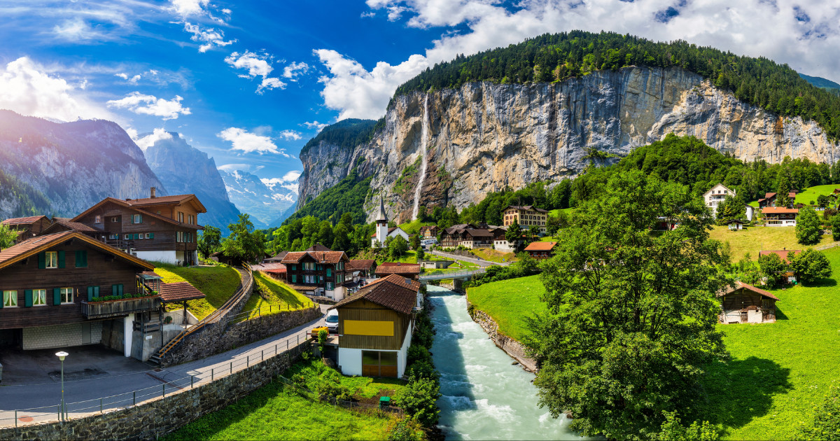 Lauterbrunnen valley with famous church and Staubbach waterfall. Lauterbrunnen village, Berner Oberland, Switzerland, Europe.