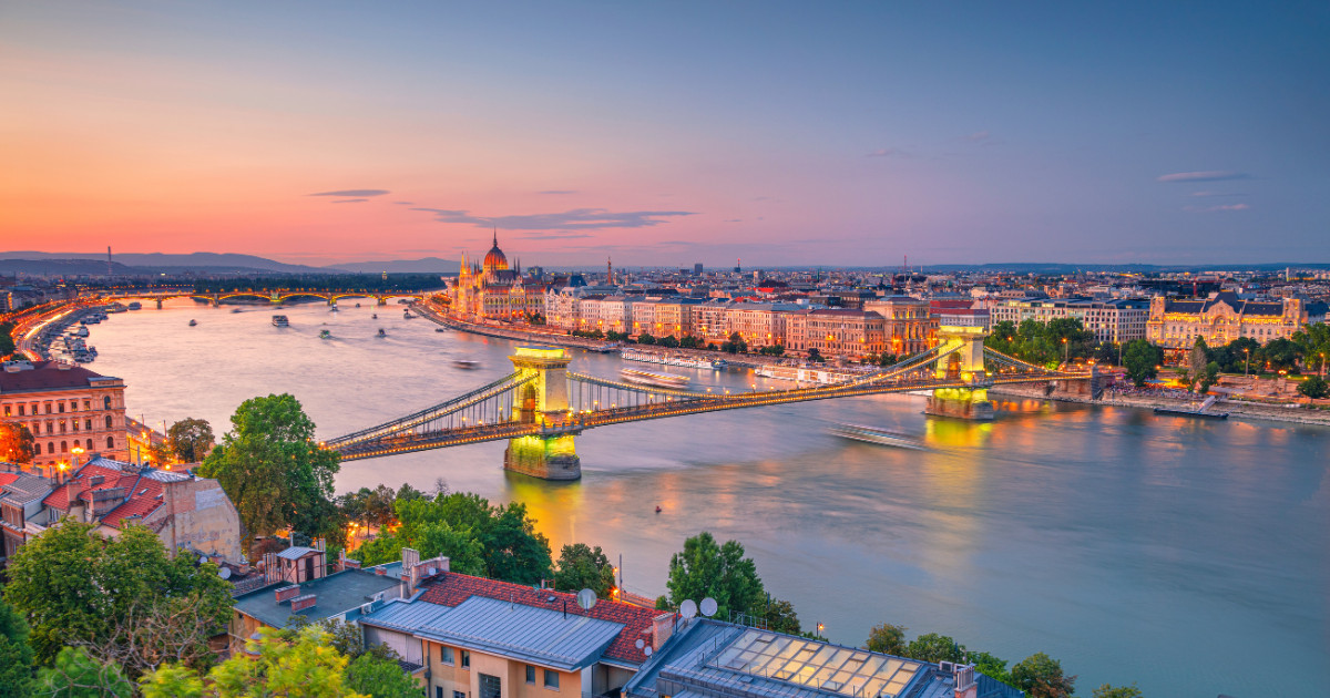 A view of Budapest at sunset with the Chain Bridge and Parliament Building.