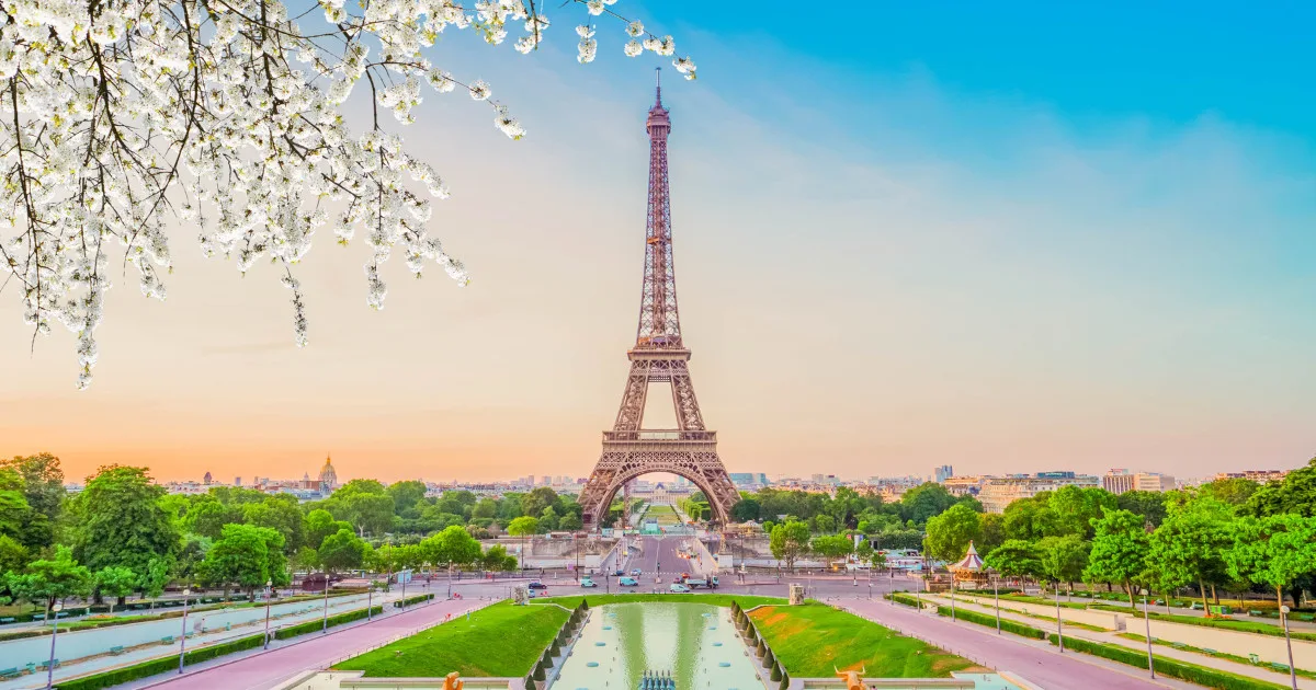 Paris Eiffel Tower and Trocadero garden at spring sunset in Paris, France. Eiffel Tower is one of the most famous landmarks of Paris