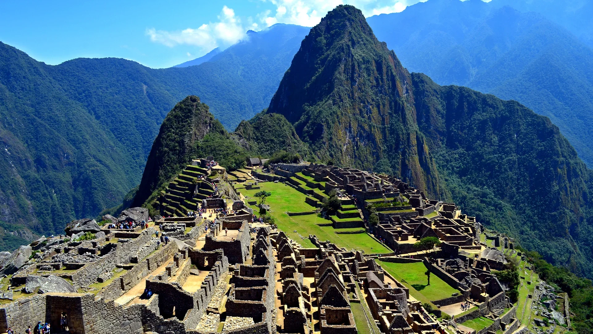 The iconic Machu Picchu, an ancient Incan city nestled high in the Andes Mountains, with terraced hills and stone structures.