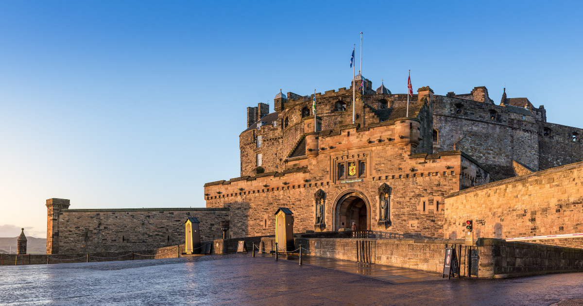 A majestic view of Edinburgh Castle, showcasing its grand entrance gate and the surrounding fortifications.