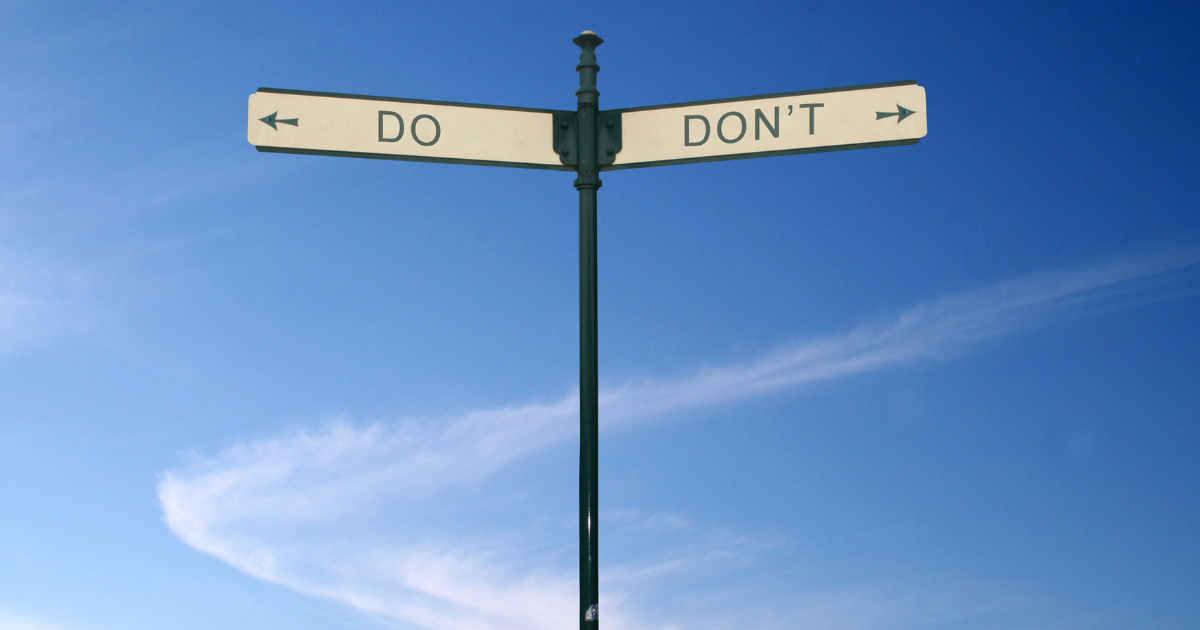 A vintage-style signpost with a green pole and white signs pointing in opposite directions, reading "DO" and "DON'T" against a blue sky.