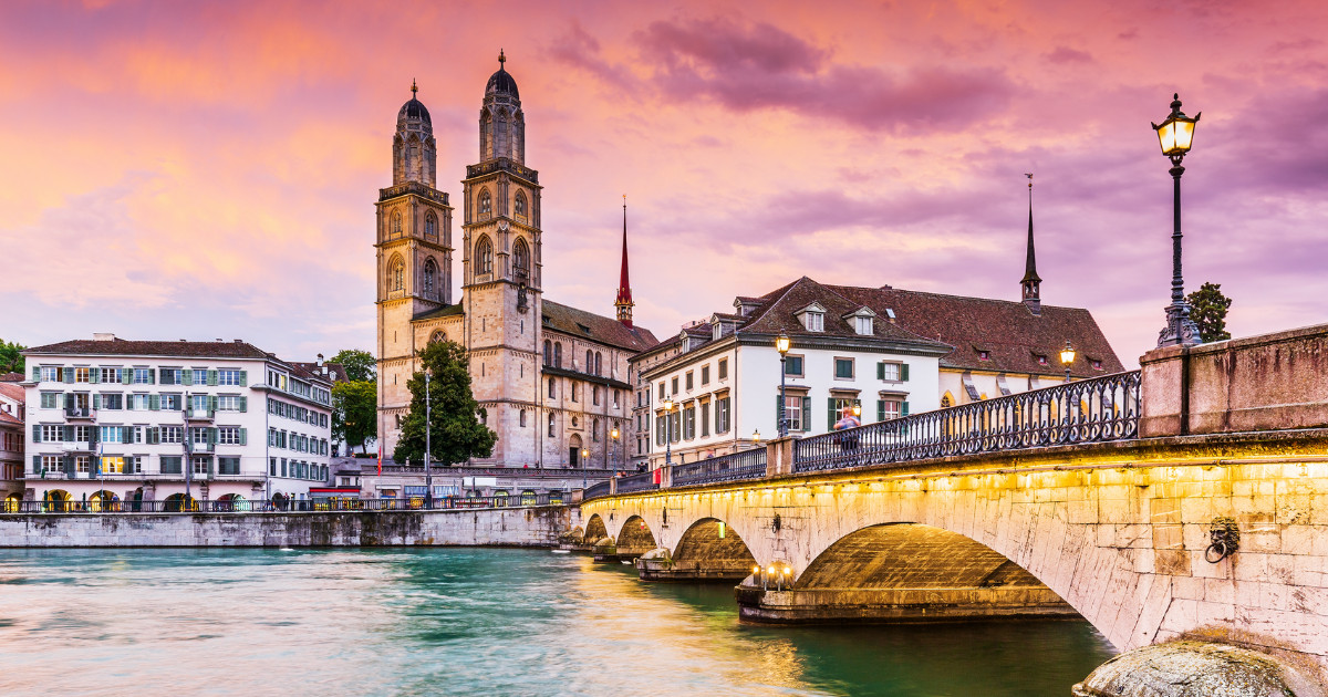 Zurich, Switzerland. View of the historic city center with famous Grossmunster Church, on the Limmat river.