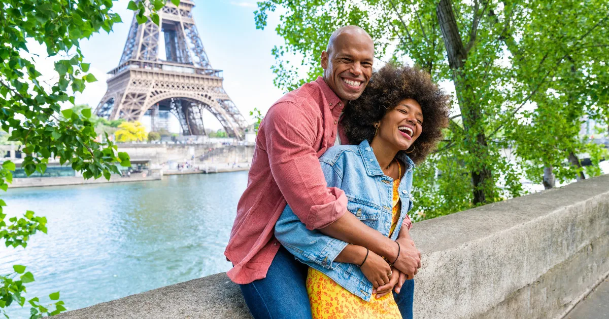 cheerful happy couple in love visiting Paris city centre and Eiffel Tower